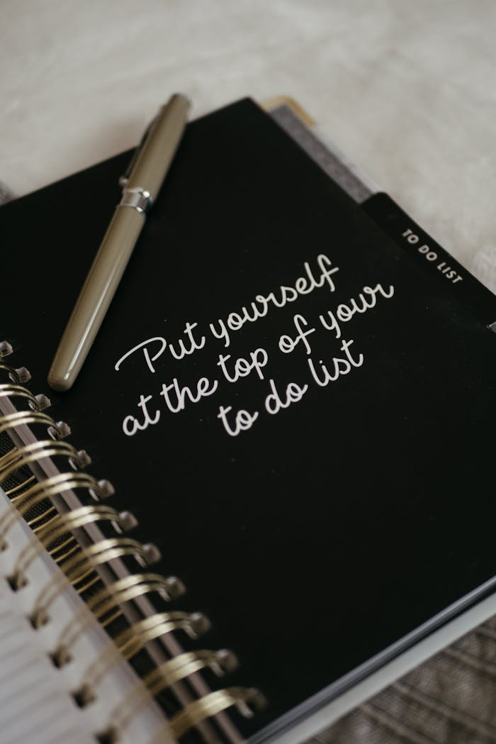 gallery-4 Close-up of a notebook with an inspirational message to prioritize yourself.