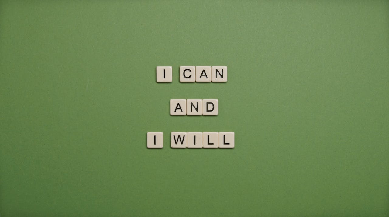 gallery-3 Inspirational message 'I Can and I Will' spelled with tile letters on a green background.